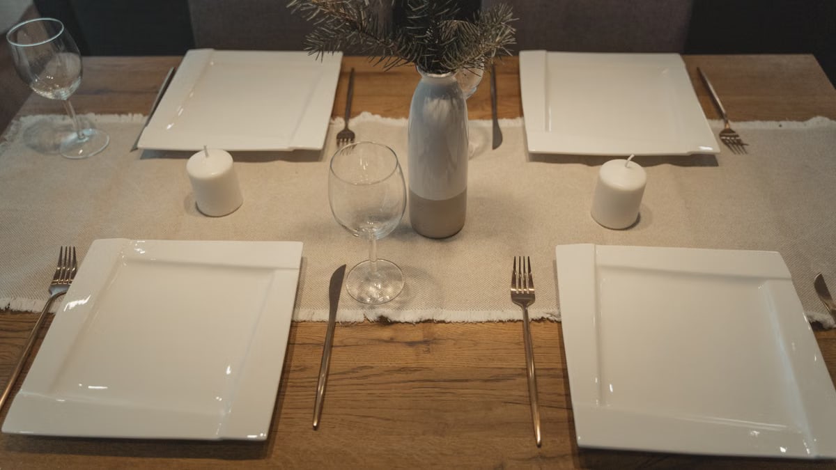 Elegant dining table setup with candles and modern decor, perfect for gatherings.